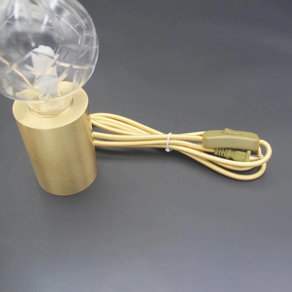 Brass crystal bulb table lamp with ornamental engraved details on elegant brass holder
