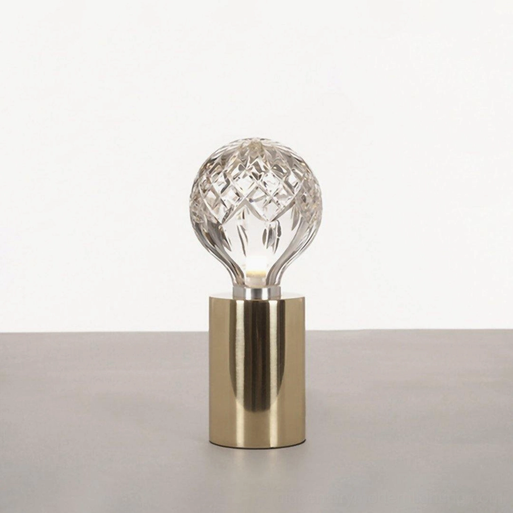 Crystal bulb table lamp with brass holder and hand-cut glass shade for contemporary interiors