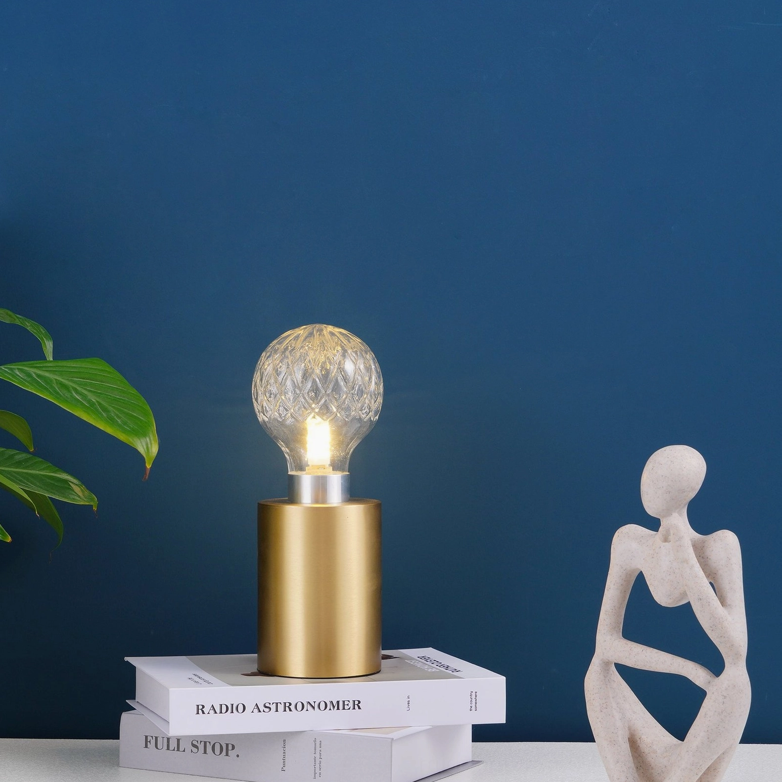 Crystal bulb table lamp detail view showing hand-cut faceted glass sphere and brass lamp holder