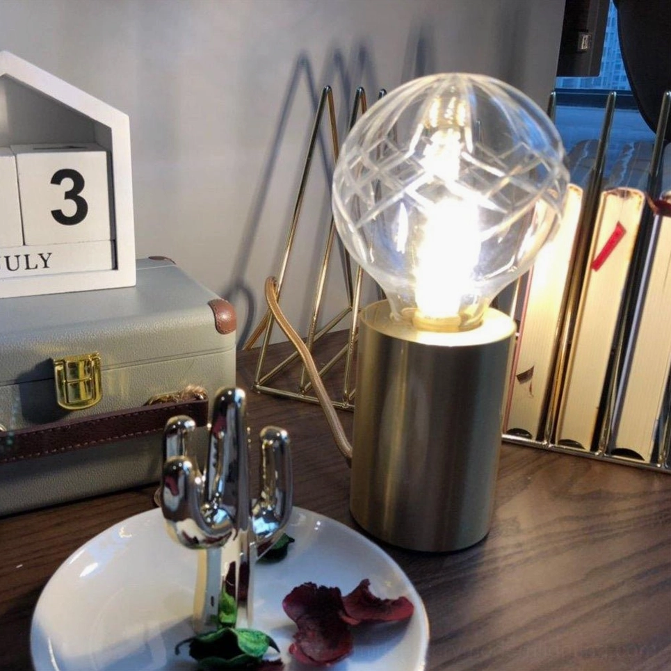 Elegant crystal bulb table lamp positioned on home office desk for task and ambient lighting