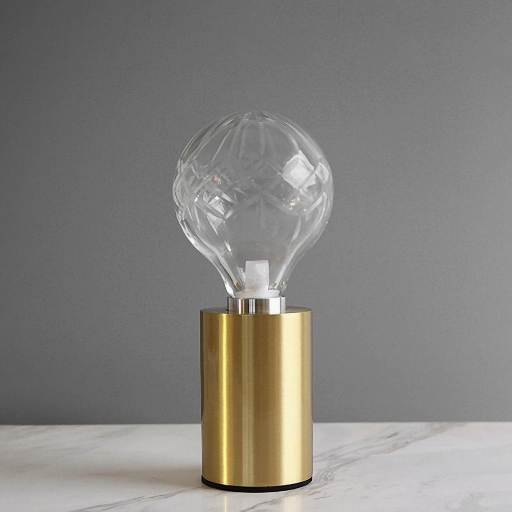 Mid-century modern crystal bulb table lamp creating sophisticated ambient glow in interior space