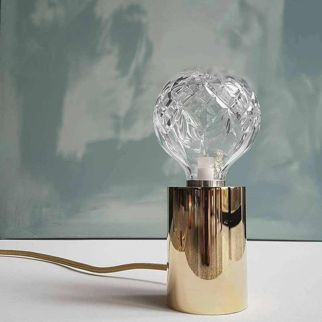 Premium crystal bulb table lamp with brass finish showing craftsmanship and design elegance