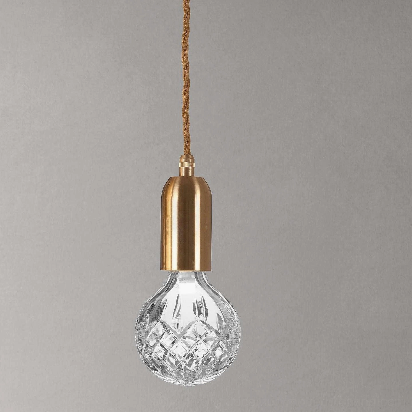 Three-head crystal bulb pendant hanging at varied heights for dynamic interior lighting design