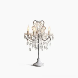Crystal candelabra table lamp with distressed grey metal frame and hanging clear crystal droplets in studio white background, showing four candle-style light bulb sockets