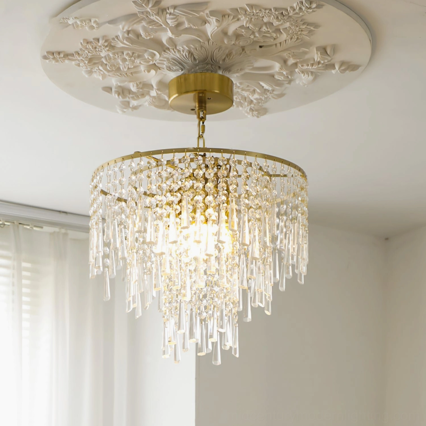 Crystal pendant light fixture mounted on decorative ceiling medallion in bedroom setting