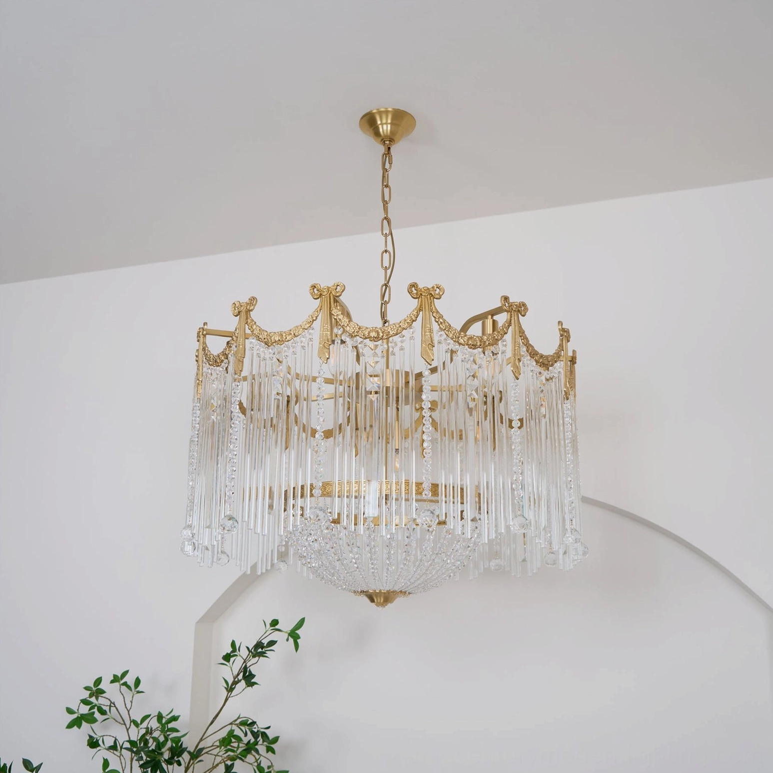 Artistic view of crystal teardrop chandelier highlighting brushed brass finish and crystal bead arrangement