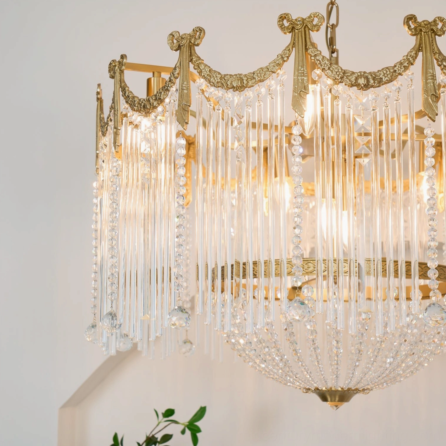 Crystal chandelier interior installation showing complete fixture with brass hardware and hanging chain