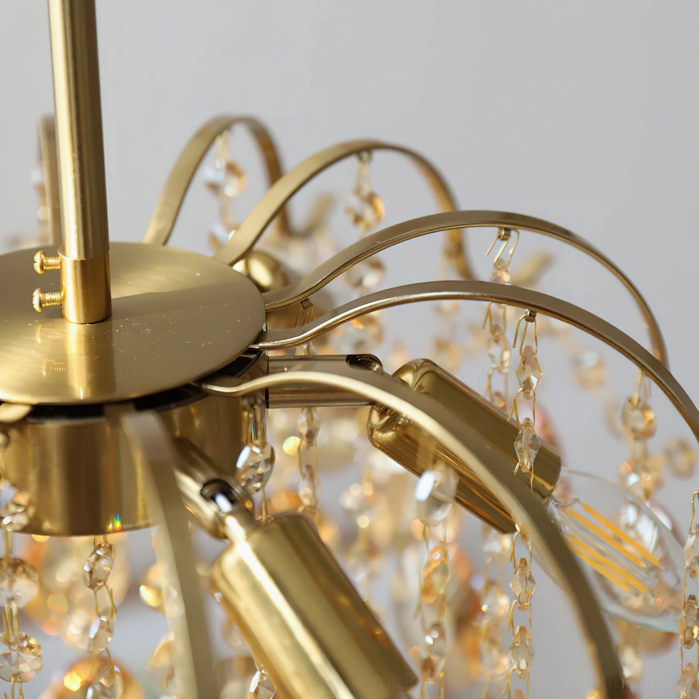 Chandelier hardware close-up showing brass gold metal parts, crystal pendants, and E14 bulb sockets detail