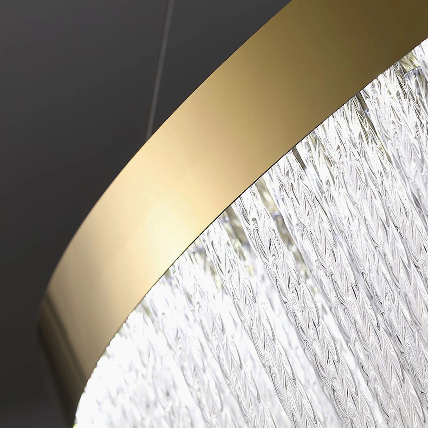 Crystal chandelier with warm amber LED light creating ambient illumination and gold frame highlights