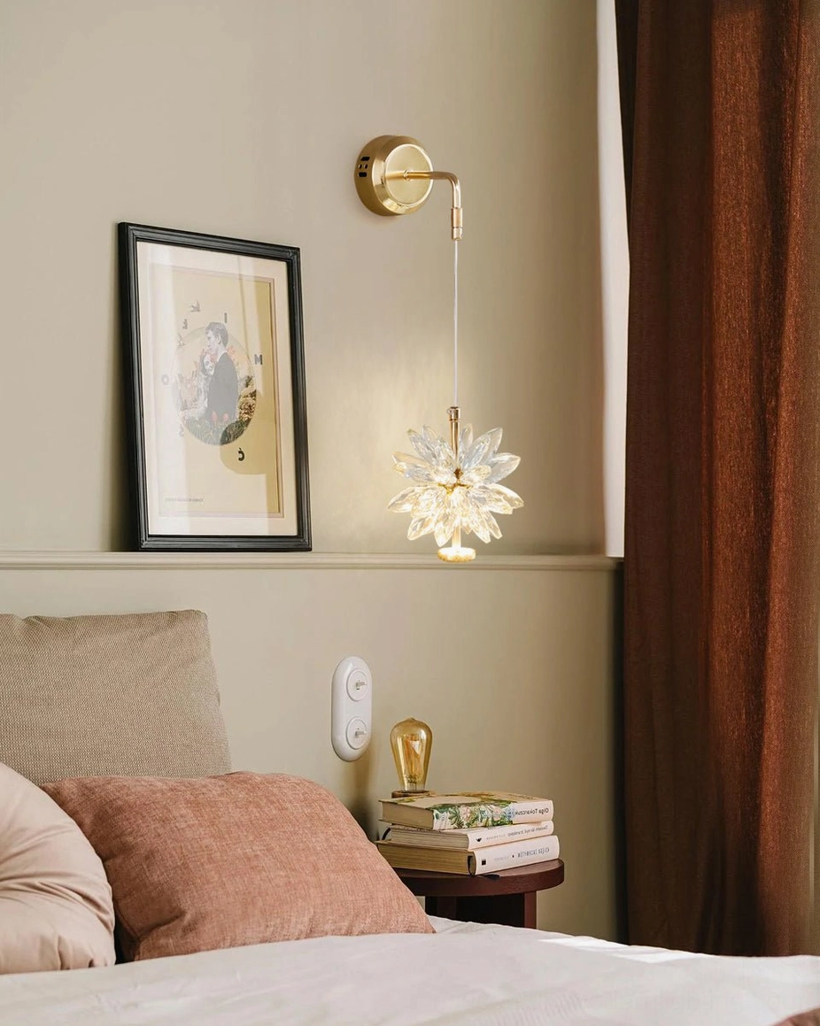 Crystal flower wall sconce mounted in cozy bedroom environment with wall art and window curtains, creating warm intimate ambiance