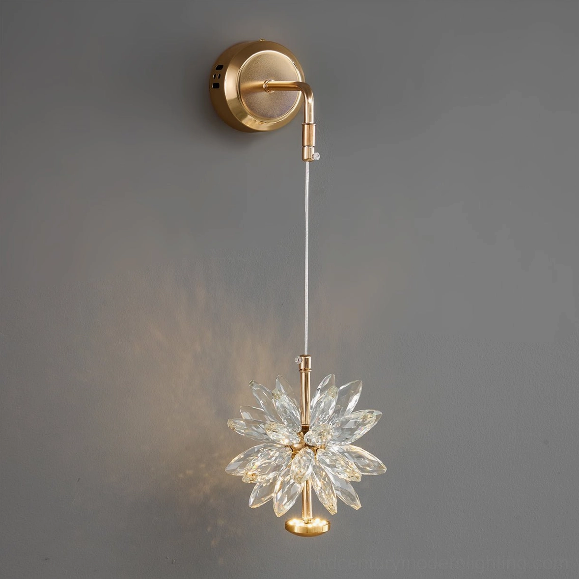 Mid-century modern crystal flower wall sconce showing detailed faceted petals and gold metal hardware in diagonal view