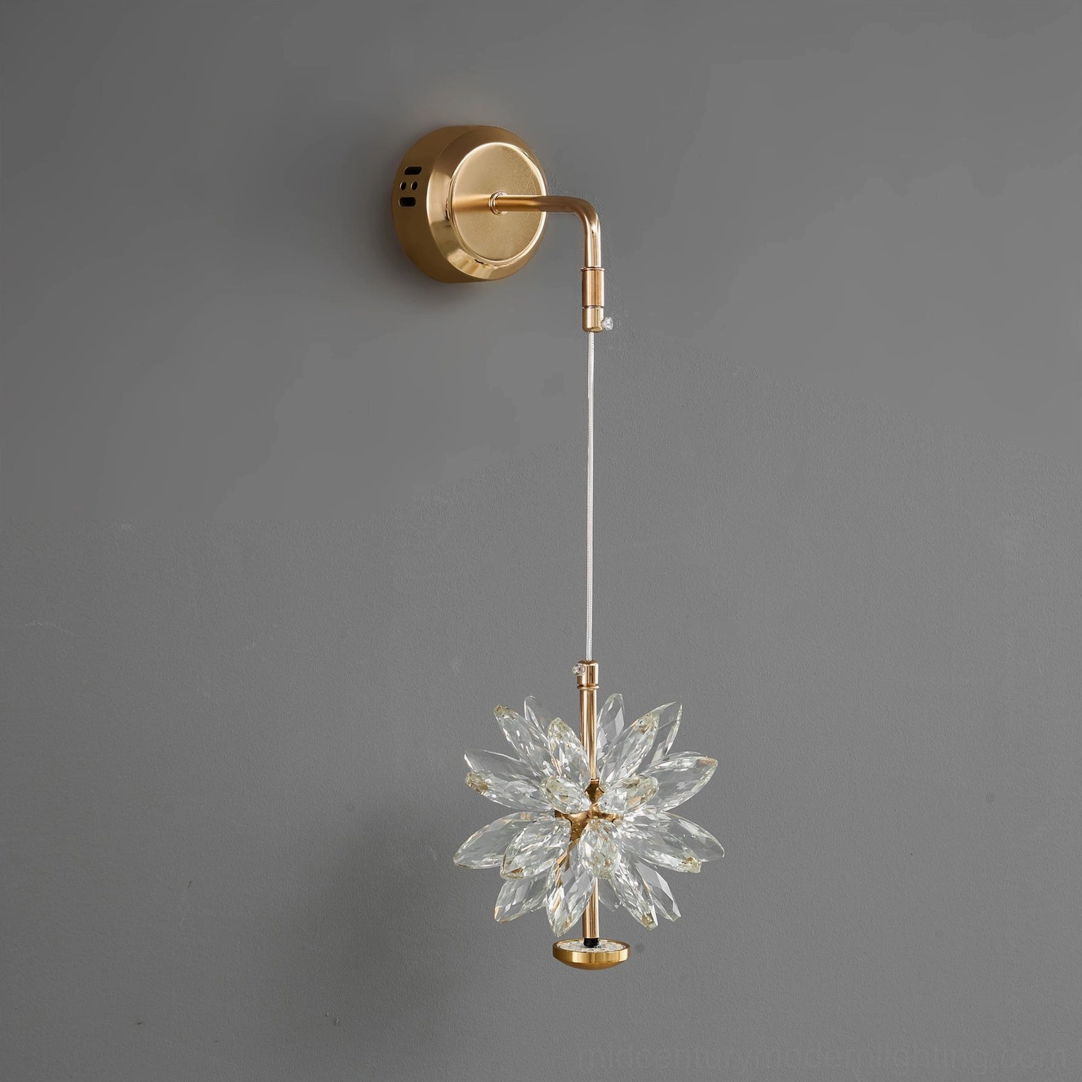 Unlit crystal flower wall sconce with gold base mounted on modern interior wall, showing the sculptural design without illumination