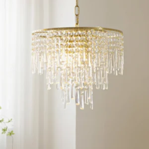 Close-up of crystal chandelier pendant glowing with warm interior light, featuring layered crystal tassel fringe and brass gold finish