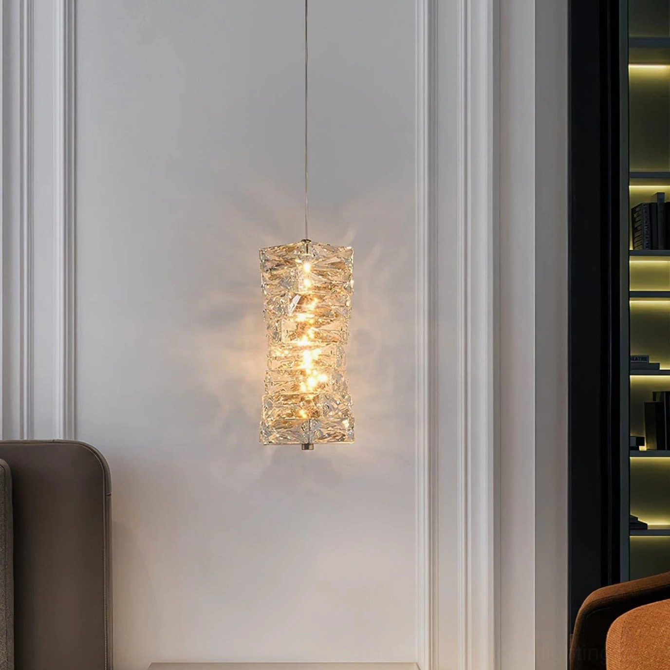 Faceted crystal pendant lamp installed in residential hallway with minimalist contemporary design aesthetic