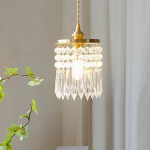 Vintage crystal pendant lamp hanging indoors with warm glow, three-quarter view