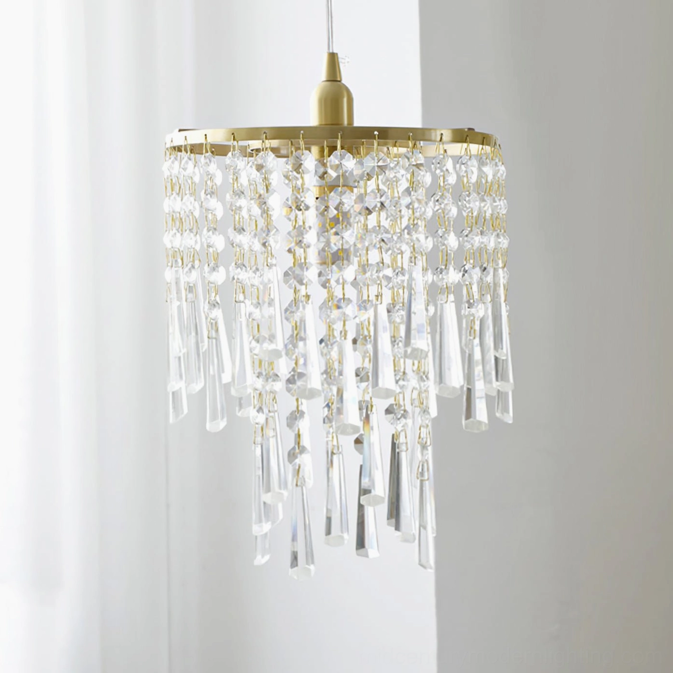 Dense round crystal top layer pendant light with long crystal tassel fringe in brass gold finish, close-up detail