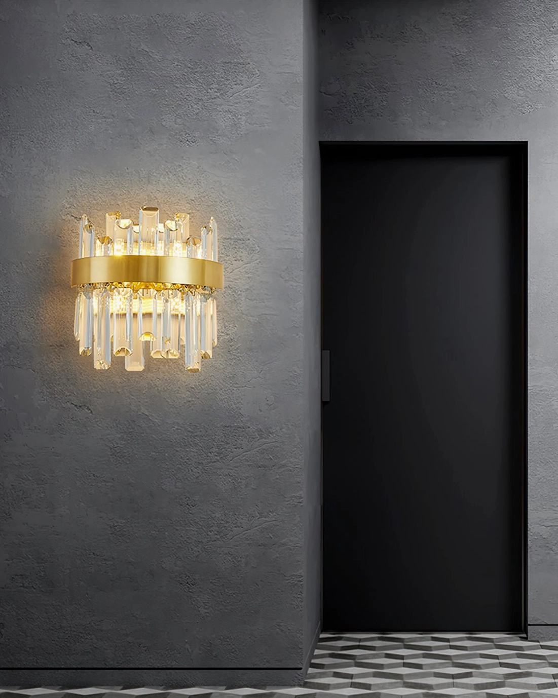 Compact brass crystal wall sconce in contemporary concrete hallway with black door, showcasing minimalist modern aesthetic