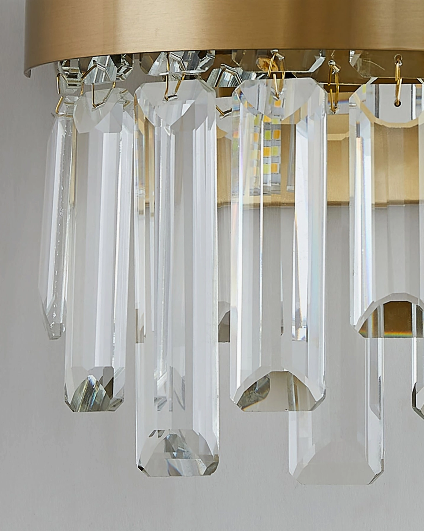 Crystal wall fixture in sophisticated interior, demonstrating how brass sconce complements contemporary home décor and ambient lighting
