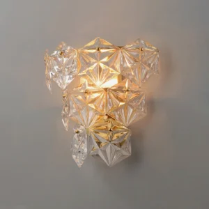 Close-up of faceted crystal clusters on modern wall sconce illuminated with warm soft glow