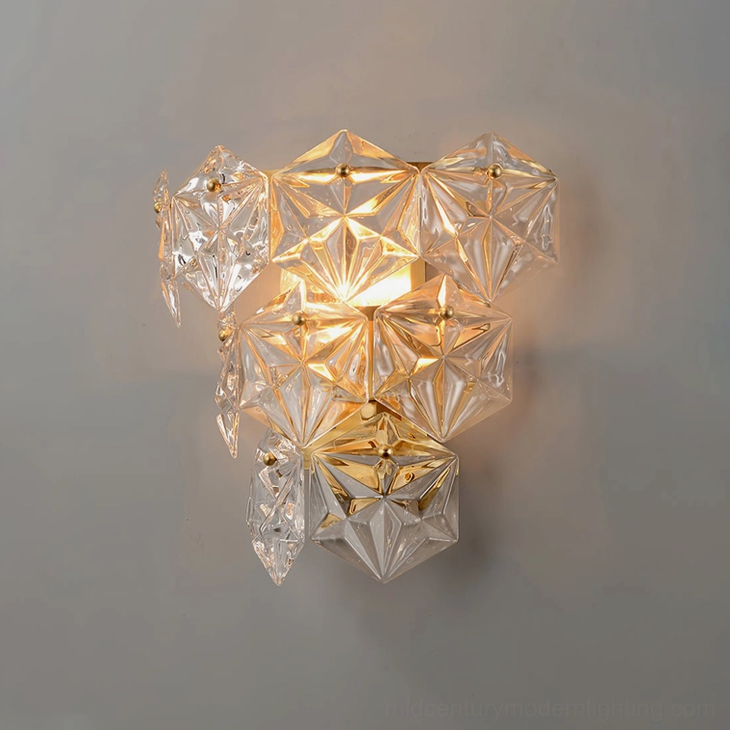 Close-up of faceted crystal clusters on modern wall sconce illuminated with warm soft glow