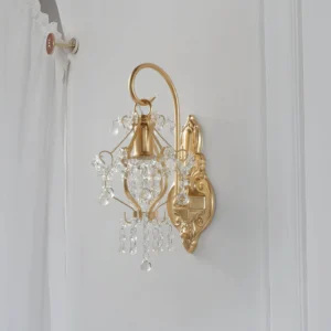 Crystal wall lamp mounted on bedroom wall with sheer white curtain showing side profile and ambient lighting in home setting