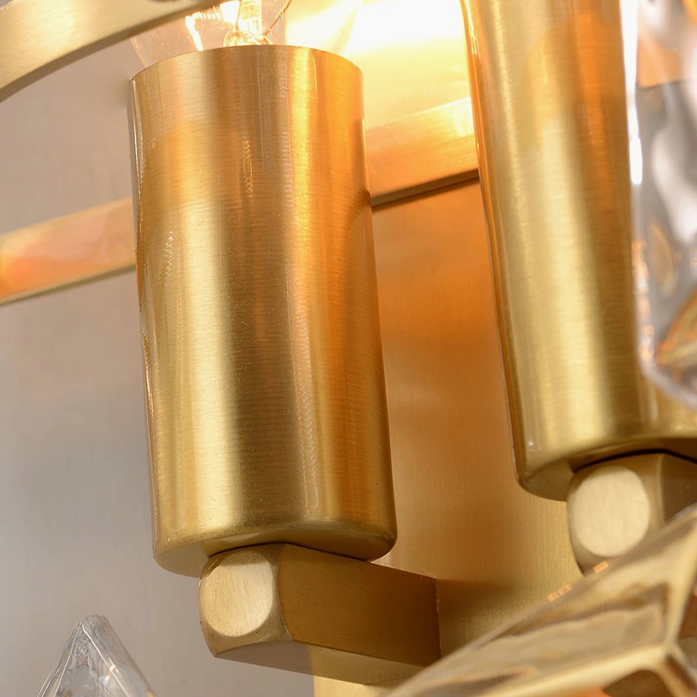 Modern crystal wall sconce installation detail with brass mounting and clear glass assembly