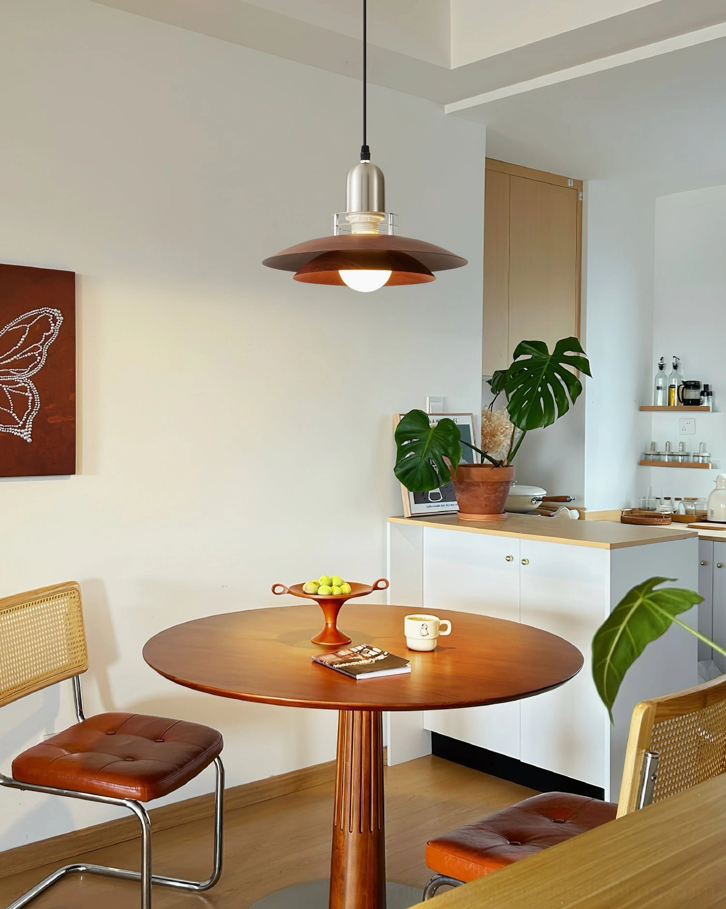 Cullen pendant light installed in minimalist kitchen-dining area with modern cabinetry and warm ambient glow