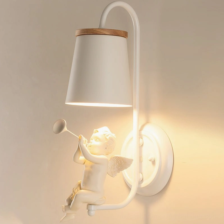 White metal angel wall fixture with trumpet-playing cupid and wood-trimmed fabric shade warm ambient glow
