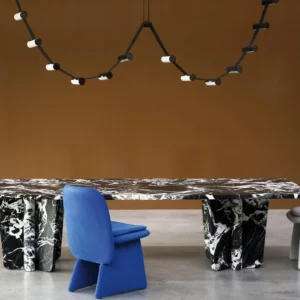 Modern wavy chandelier suspended in luxury dining room above marble table, matte black metal frame with white lamp heads