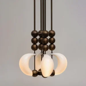 Side view of modern curved glass pendant chandelier with brass metal rods and spherical beads - sculptural hanging light fixture