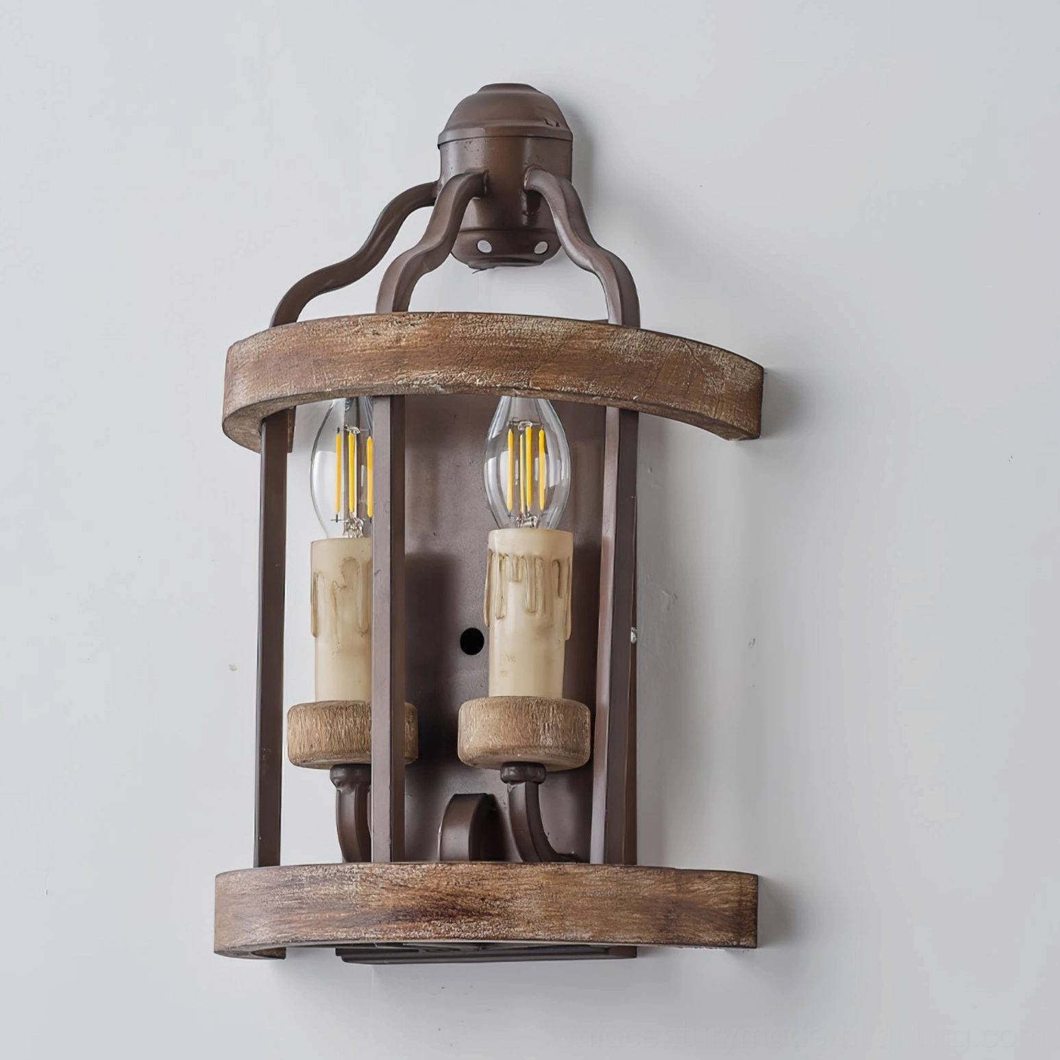 Curved rustic double candle wall lamp with brown metal and distressed wood trim on off-white wall