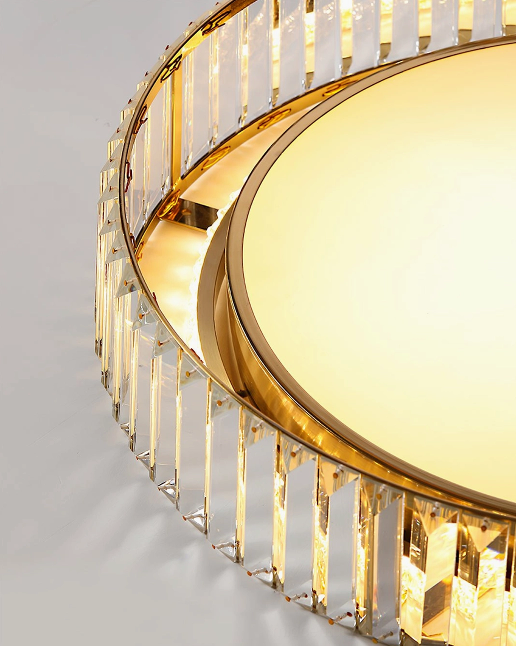 Curzon Ceiling Lamp close-up detail - side view of gold metal frame and faceted crystal strips with light refraction