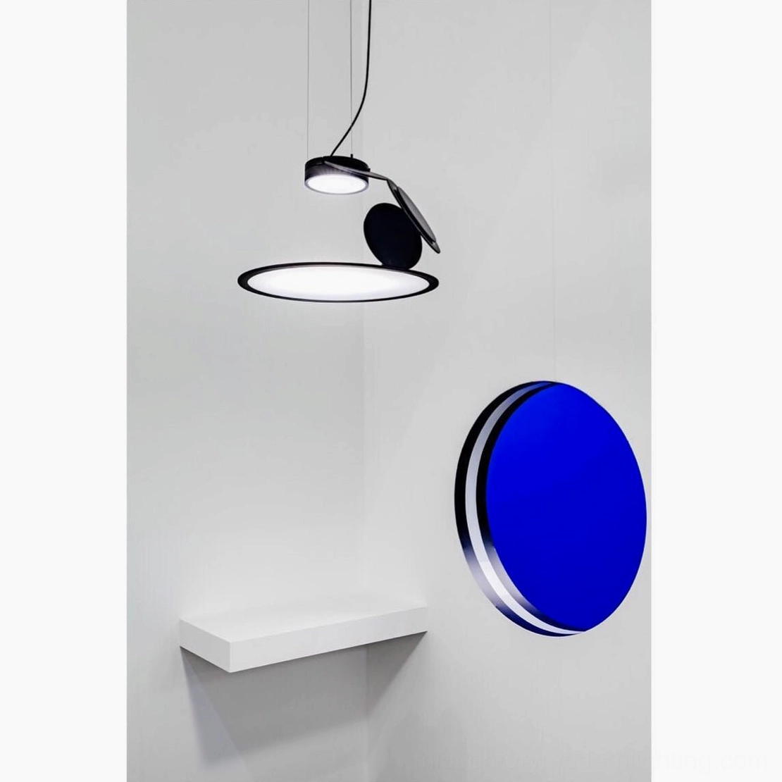 Cut pendant lamp black disc pendant front close-up blue wall decor