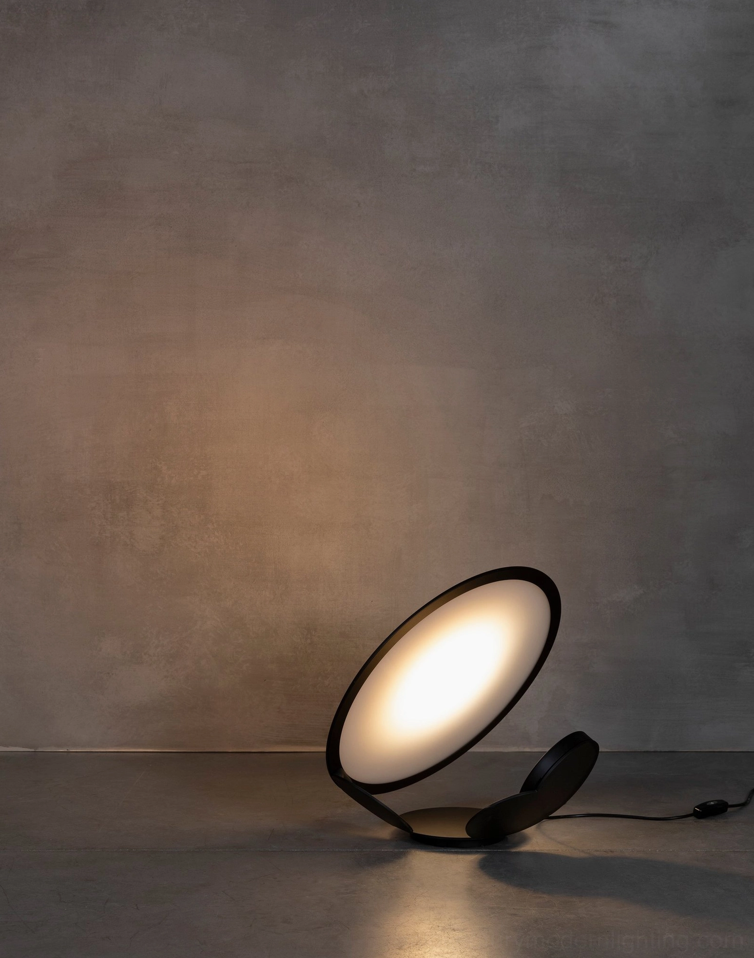 Cut geometric table lamp detail showing precision laser-cut folded circular panels and LED diffuser technology
