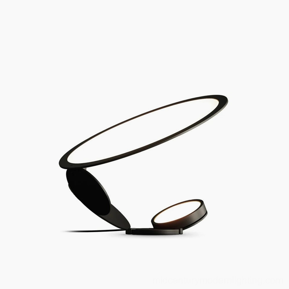 Cut modern table lamp with dual laser-cut geometric light diffusers in matte black finish, front studio view