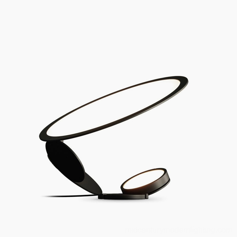Cut modern table lamp in matte black finish featuring laser-cut folded geometric panels with warm light option