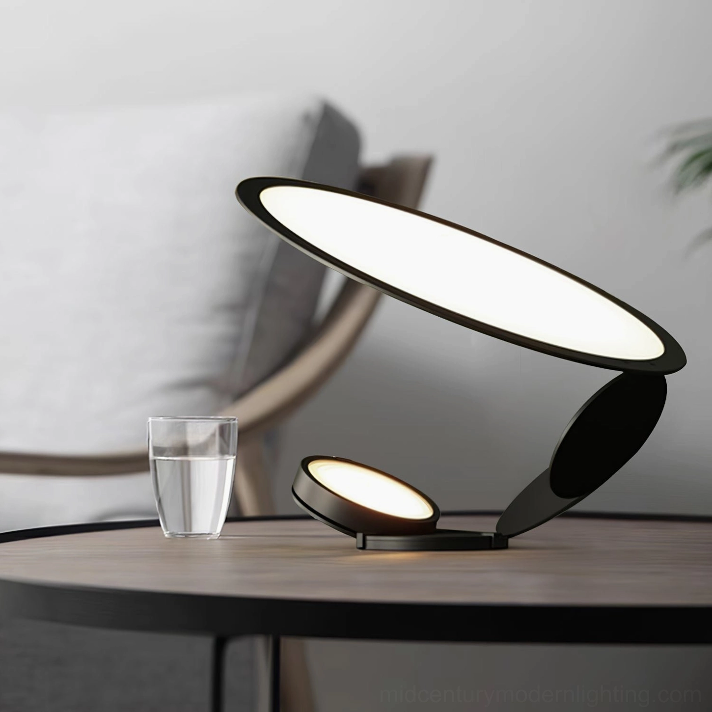 Side view of modern dual-head LED table lamp with matte black metal finish creating warm diffused lighting