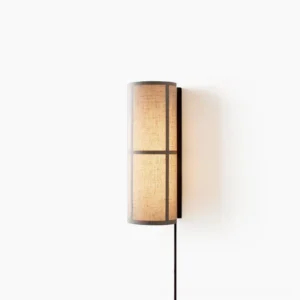 Modern cylinder fabric wall lamp with black metal frame and linen shade front view on white background