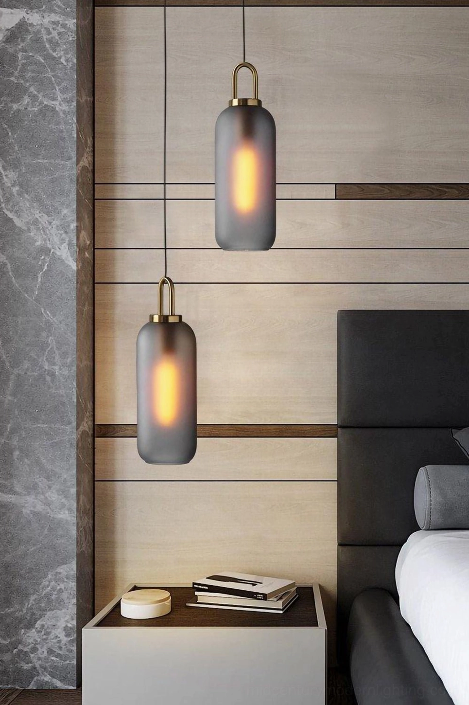 Frosted dark gray capsule cylindrical smoked glass pendant lamp in modern bedroom with warm glowing light
