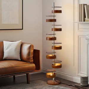 Stacked cylinder floor lamp in modern living room with leather sofa, warm ambient light creating layered glow effect