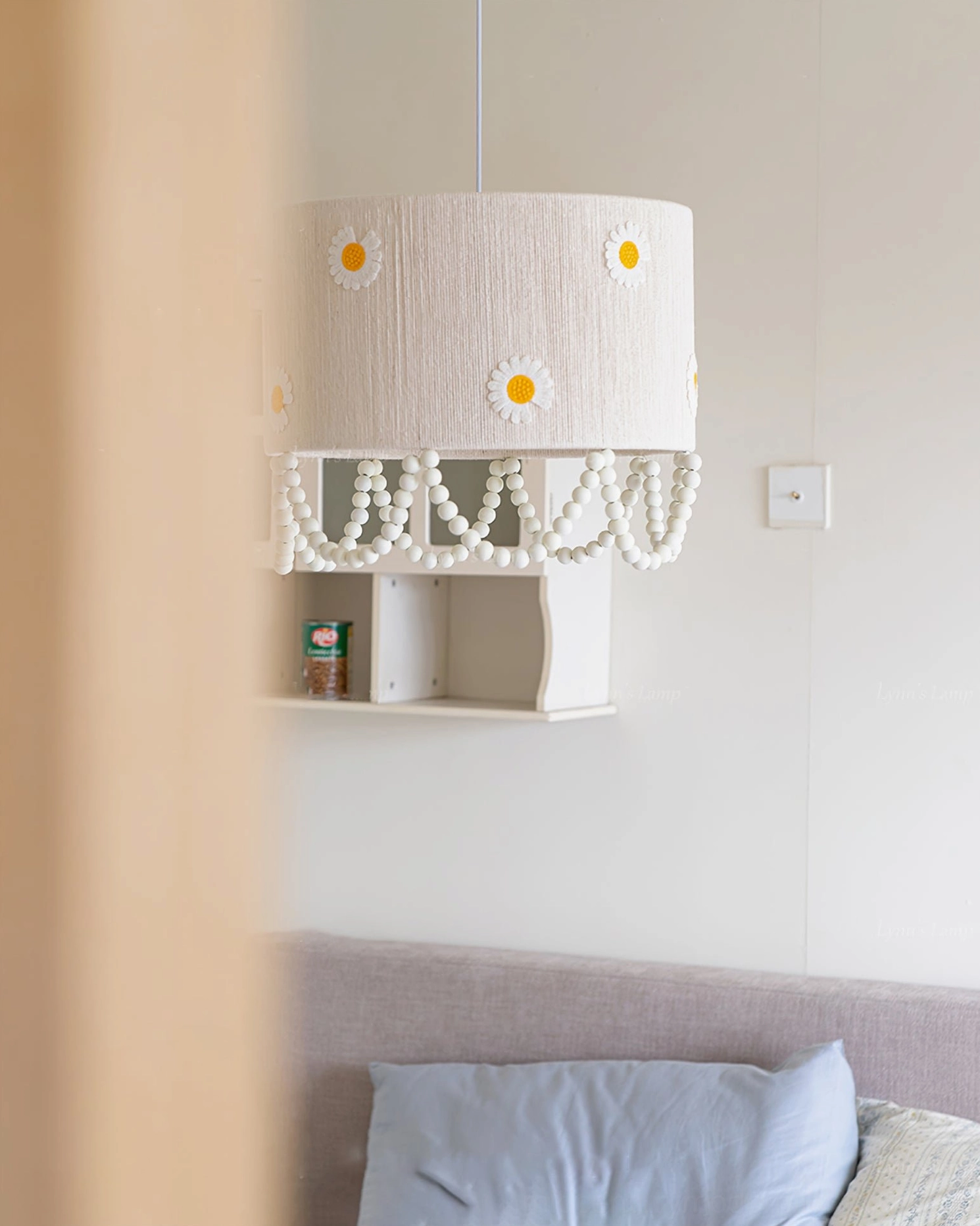 Daisy flower pendant lamp installed in bedroom with wall switch visible warm glow illuminated over bed