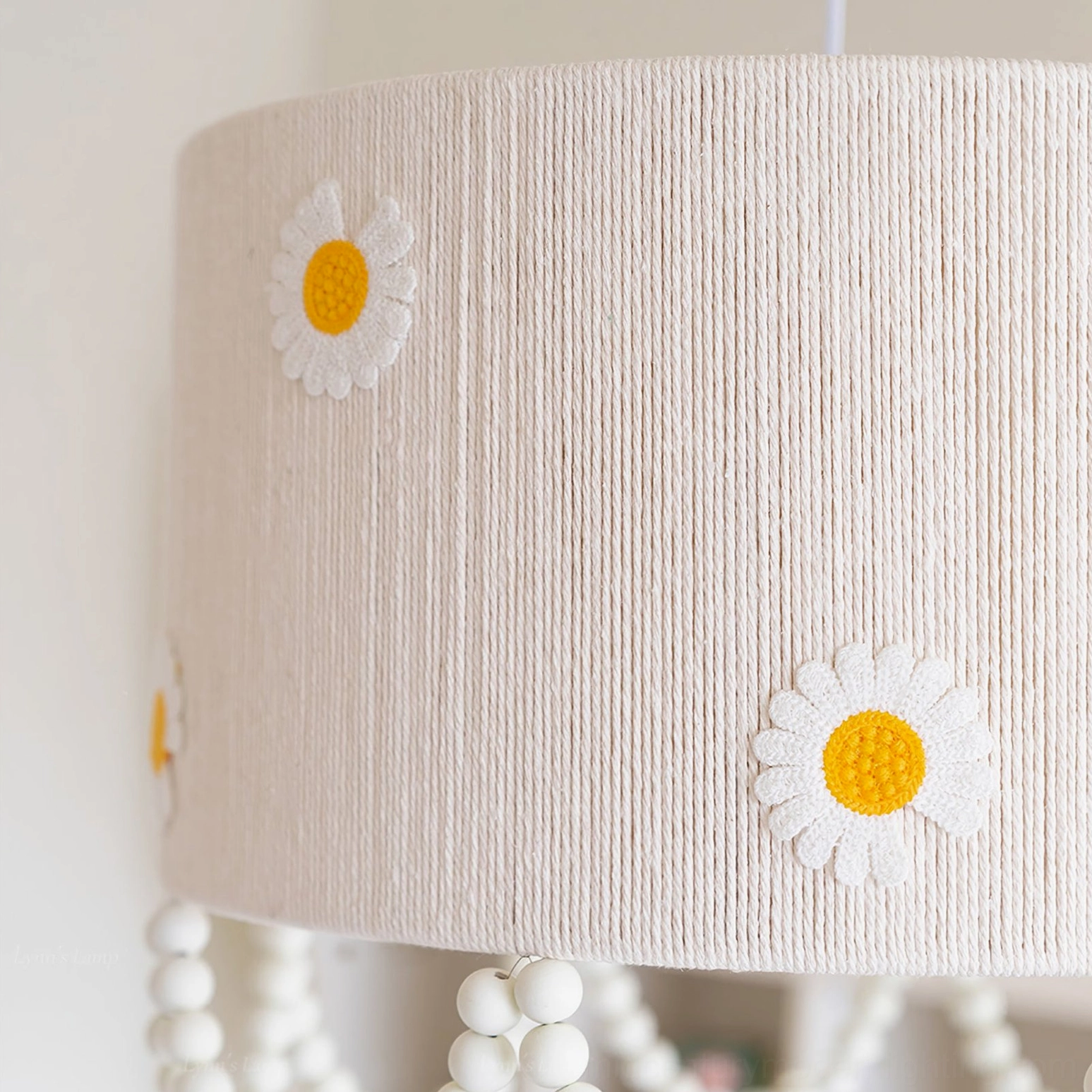 Side close-up of daisy flower pendant lamp shade vertical linen texture embroidered daisy flowers botanical design