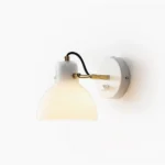 Daniel mid-century modern swing arm wall lamp with brass finish and frosted white glass shade on plain white background
