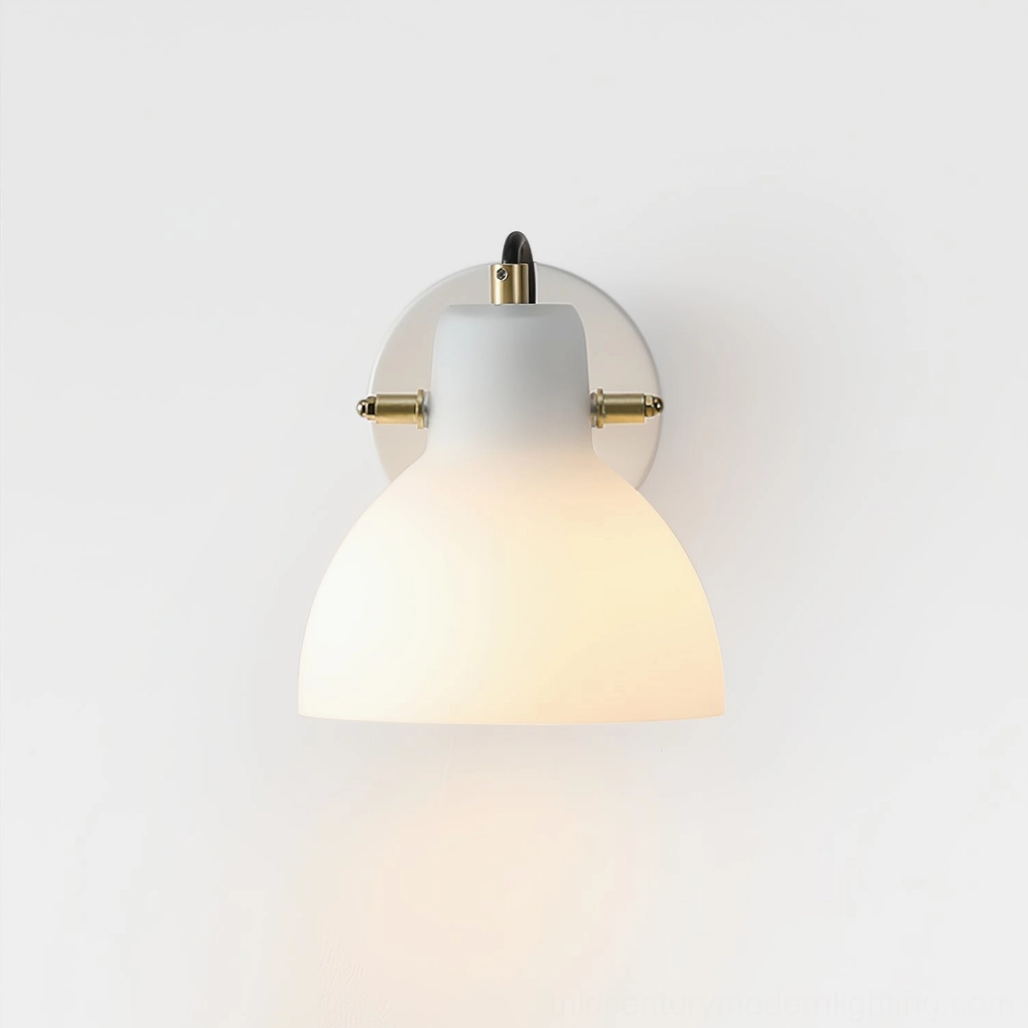 Low-angle view of modern wall-mounted reading lamp featuring brass metalwork connections and frosted glass diffuser