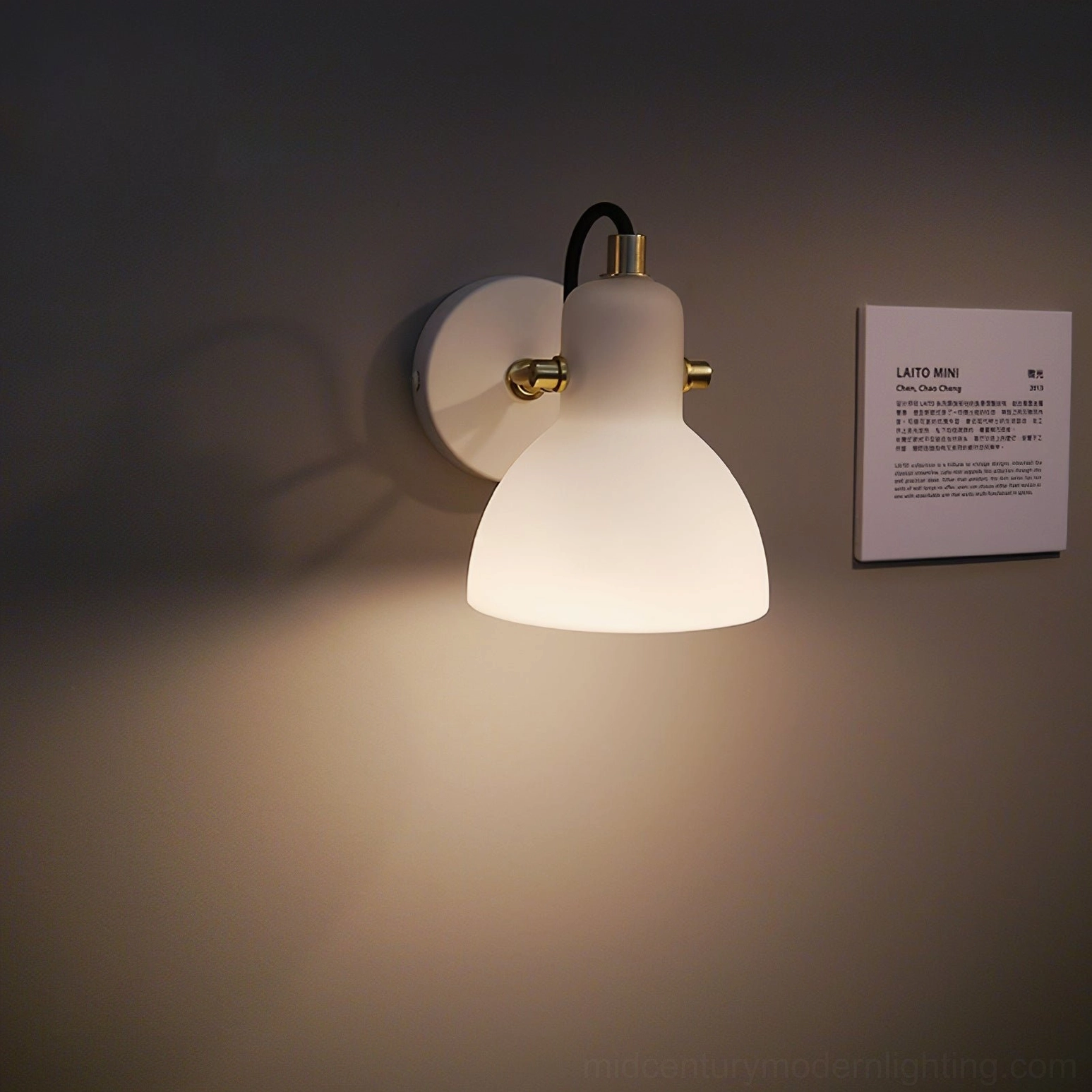 Minimalist Nordic-style wall sconce with warm glow on dark accent wall background