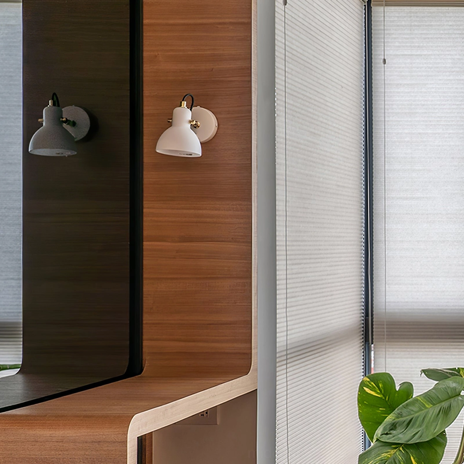 Pair of matching Daniel wall sconces installed symmetrically in modern bathroom vanity zone for balanced lighting