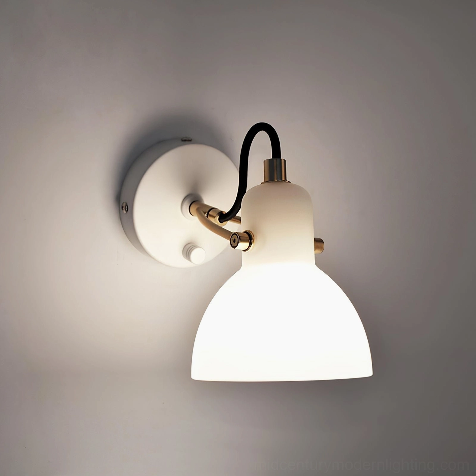 Sculptural wall sconce with frosted glass diffuser creating soft, directional ambient light