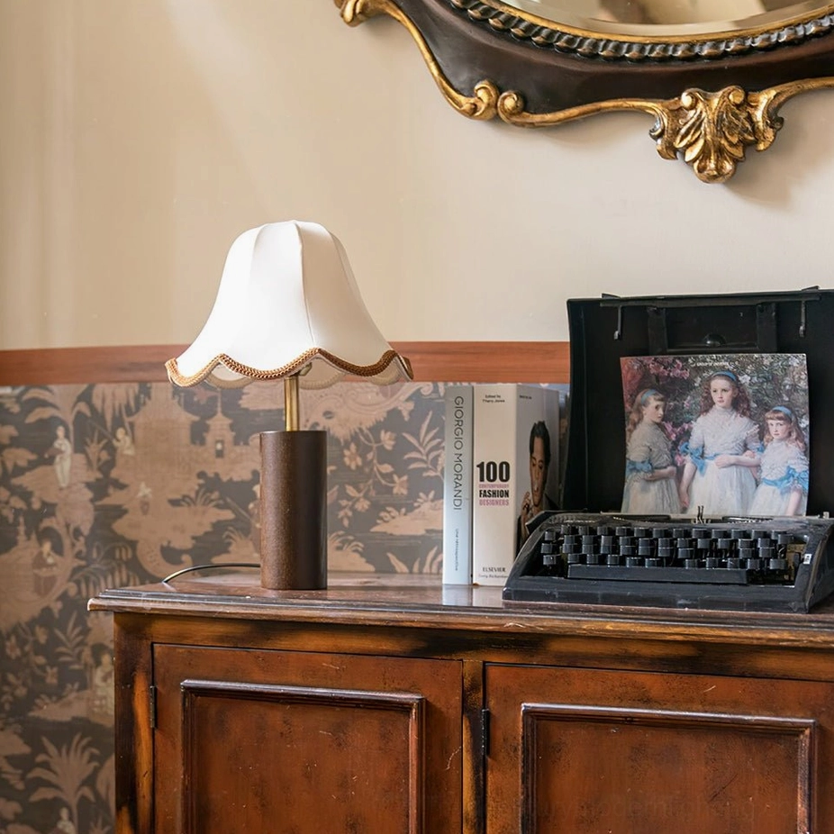 Danika table lamp frontal flat view on vintage dresser with vintage photo display and wallpaper backdrop