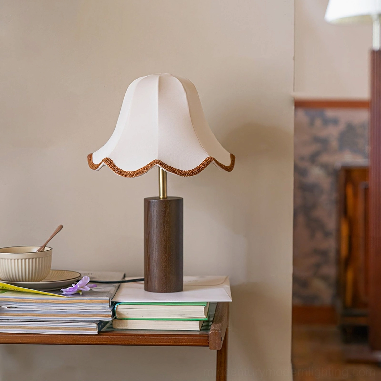 Danika unlit table lamp on side table with stacked books and decorative bowl, home interior setting