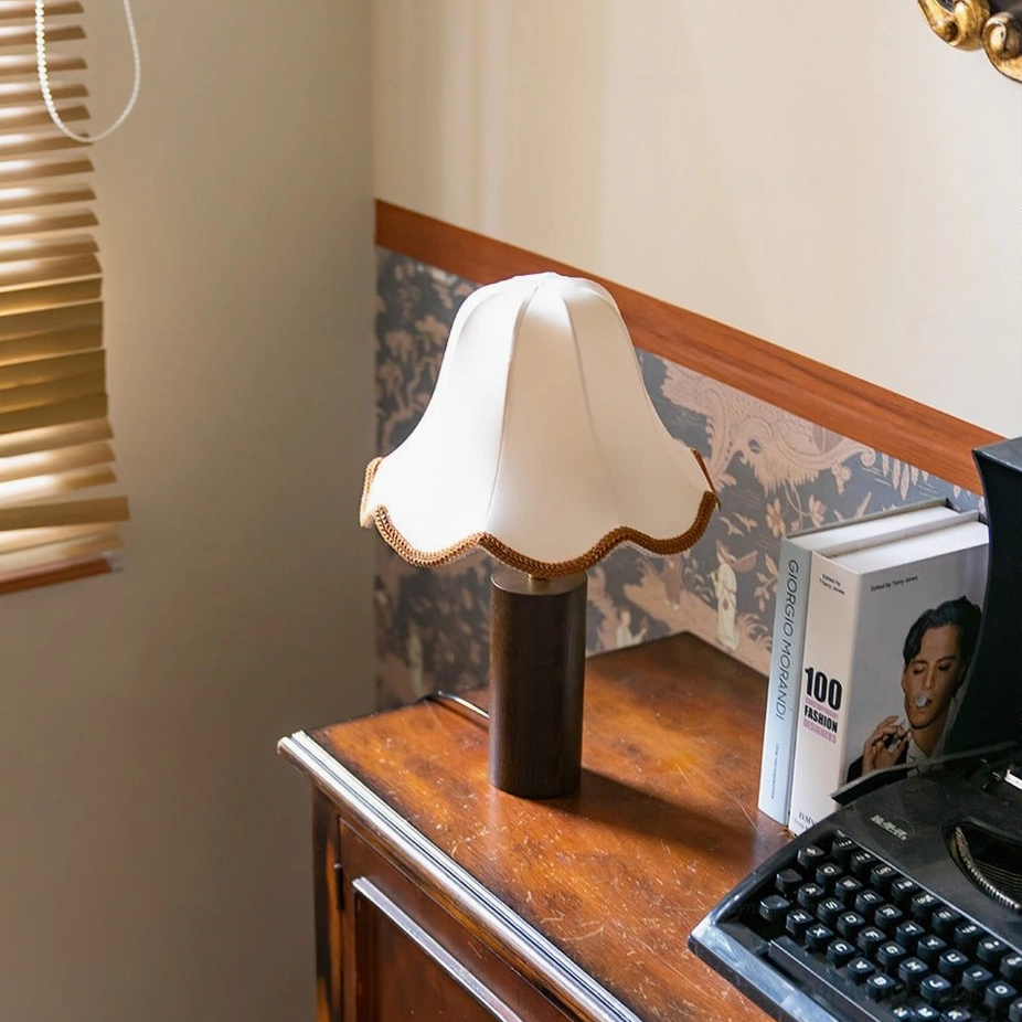 Danika mid-century lamp on vintage wooden dresser with floral wallpaper background, side profile view